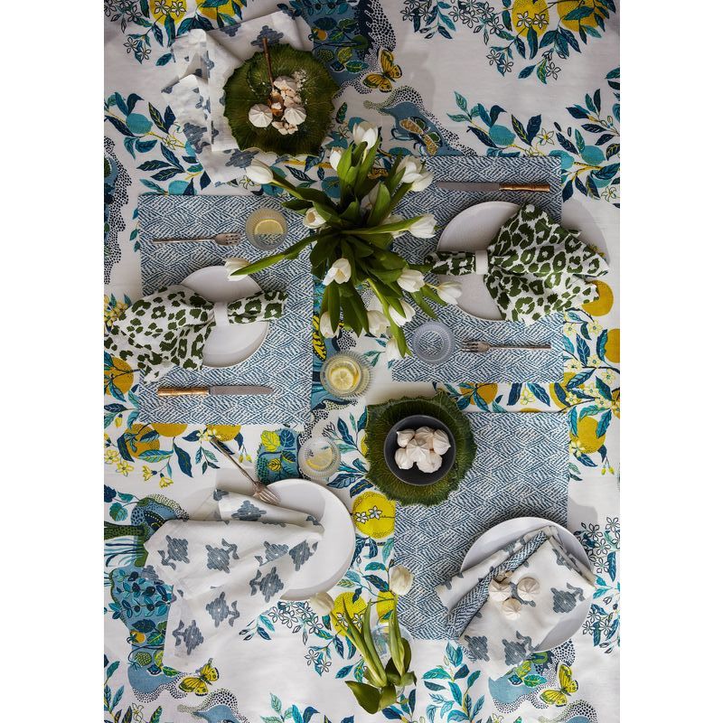 Table settings don’t get much more eclectic than this! Even so, the palette is relatively restrained—several blues, green, yellow, and white. Find the place mats here, the blue-and-white napkins here, and the leopard-print napkins here.
